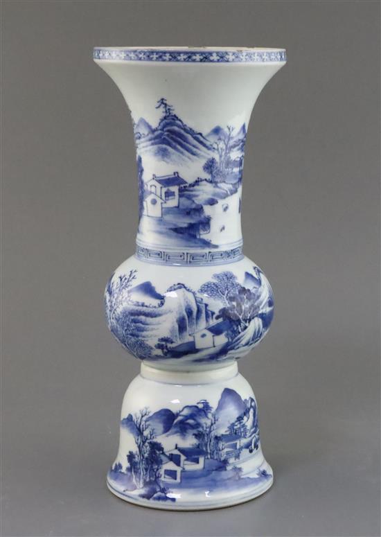 A Chinese blue and white beaker landscape vase, gu, Kangxi period, H. 30.5cm, lean to one side